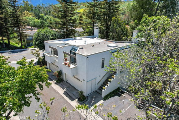 Front view of a multi-level house with a rooftop and garage.