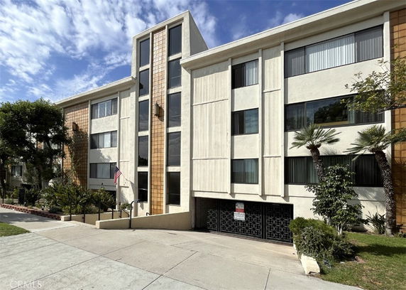 Front view of a multi-story building with large windows and a modern design.