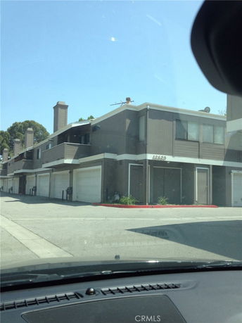 Front view of a multi-story building with garages.