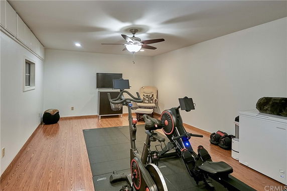 Indoor exercise room with stationary bikes and workout equipment.