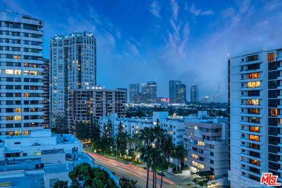 Panoramic view of tall buildings and city skyline during dusk.
