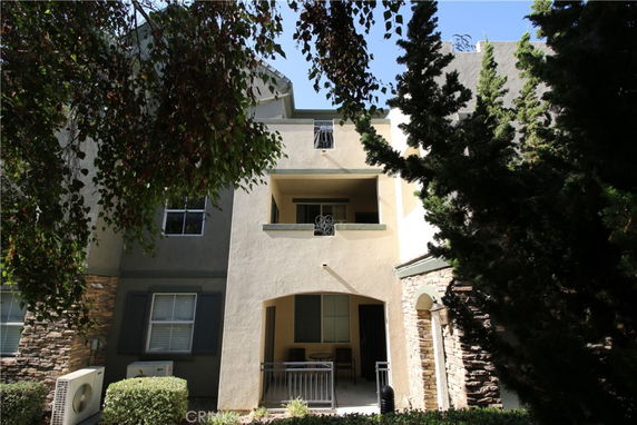 Front view of a multi-story residential building with balconies.