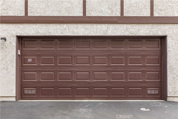 Front view of a building's garage door with brown panels.