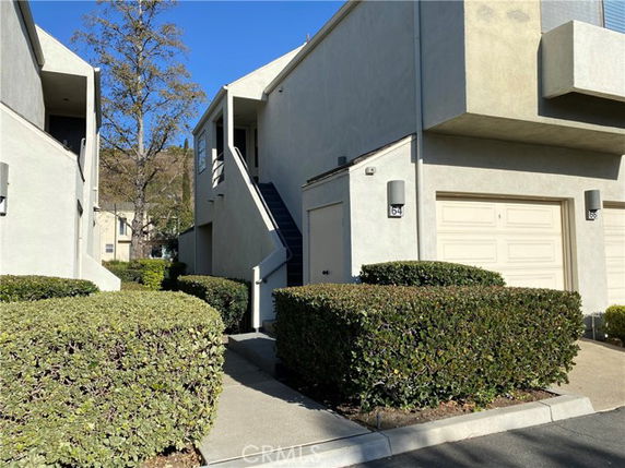Front view of a two-story building with stairs leading to the upper level.