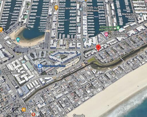 Aerial view of a marina with boats and surrounding buildings.