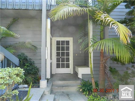 Front view of a house with a porch and entrance door.