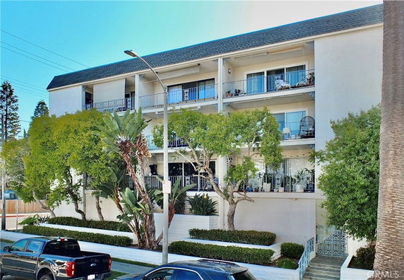 Front view of a multi-story residential building with balconies.
