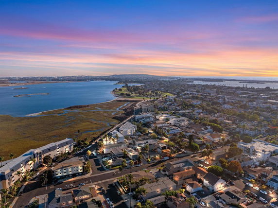 Panoramic view of a coastal cityscape at sunset.