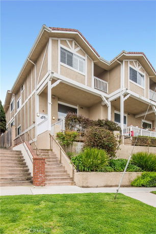 Front view of a two-story house with stepped entryway.