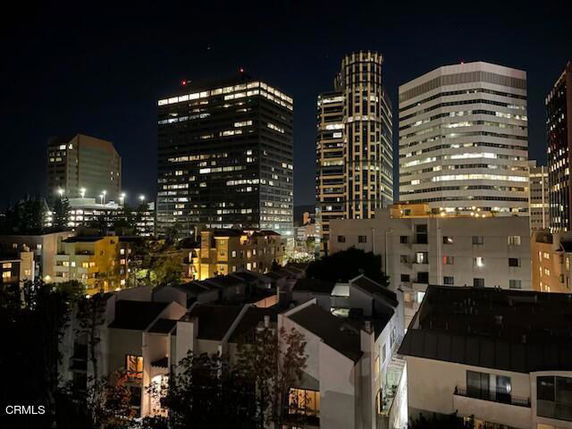 Nighttime view of cityscape with multiple high-rise buildings.