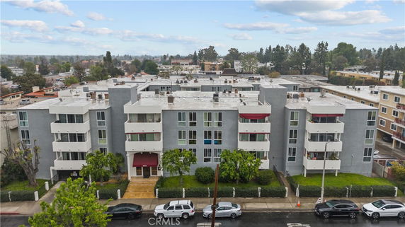 Front view of a multi-story residential building with balconies.