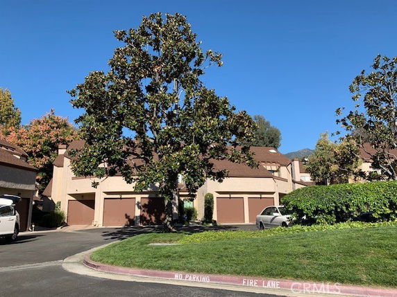 Front view of multiple two-story houses with garages.