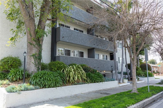 Front view of a multi-story building with balconies.