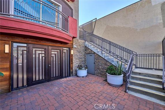Front view of a building with metal doors and exterior stairs.