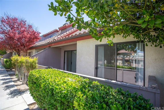 Front view of a house with a sliding glass door and a tiled roof.