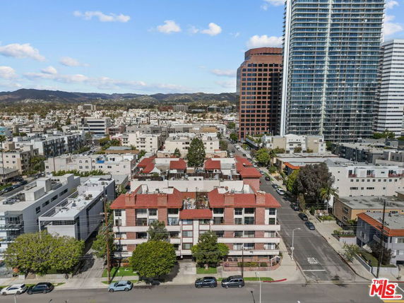 Aerial view of urban landscape with multiple residential and commercial buildings.