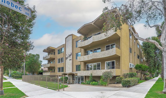Front view of a multi-story apartment building with curved balconies.