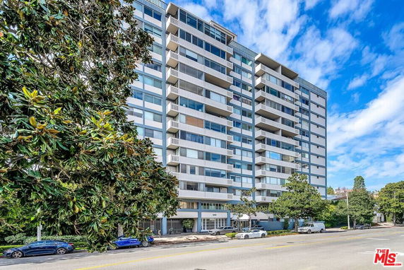 Front view of a multi-story residential building with balconies.