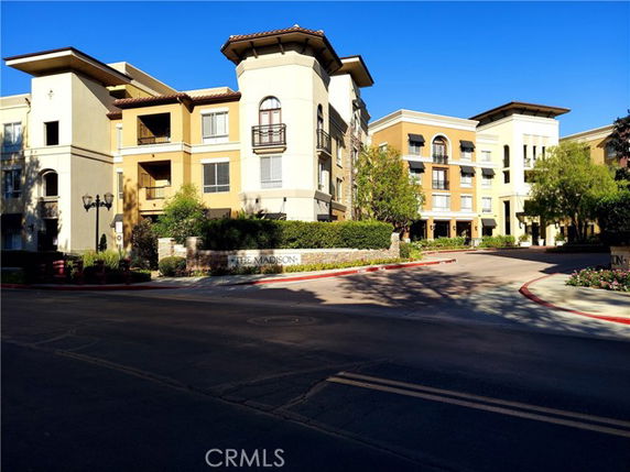 Front view of a multi-story residential building with balconies.
