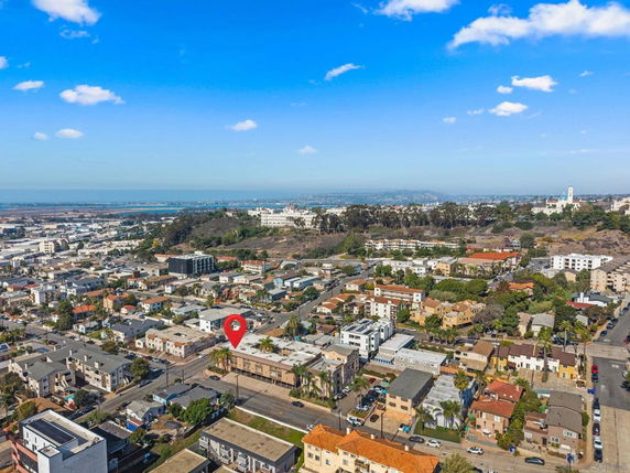 Panoramic aerial view of a suburban area with houses and buildings.