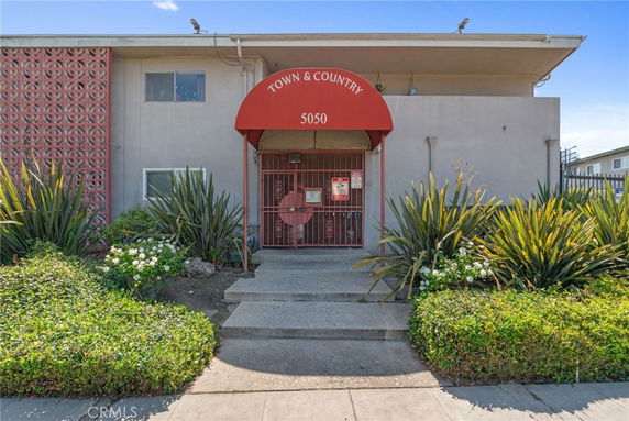 Front view of a building with an entrance and a red canopy labeled 'Town & Country 5050'.