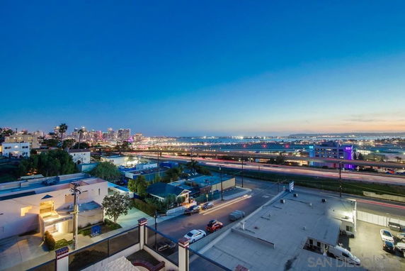 Panoramic view of cityscape with buildings and roads at dusk.