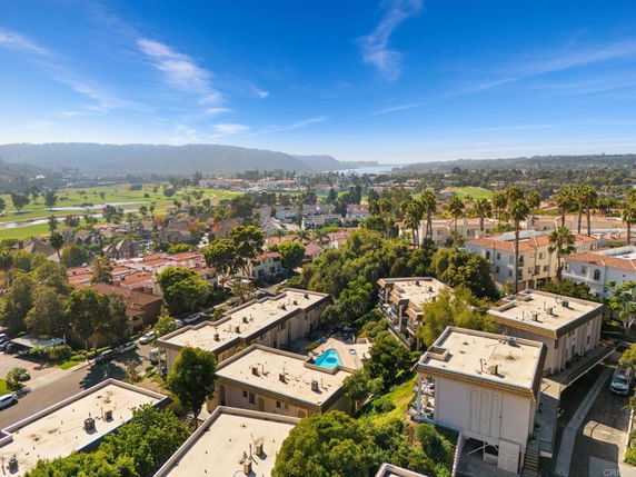 Panoramic view of residential area with multiple buildings and lush greenery.