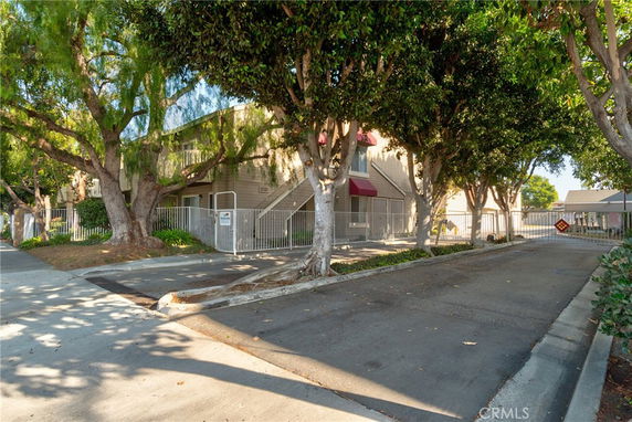 Front view of a residential building with gated entrance.