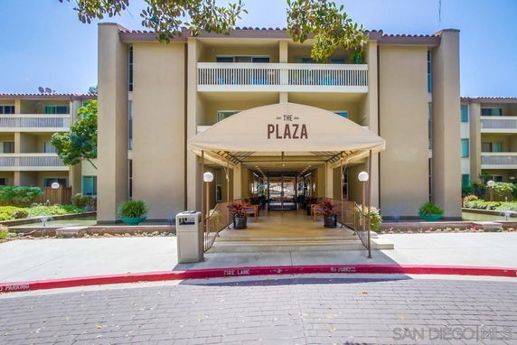 Front view of a multi-story building with a canopy entrance labeled The Plaza.