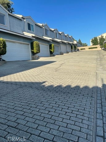 Front view of a row of attached houses with garages.