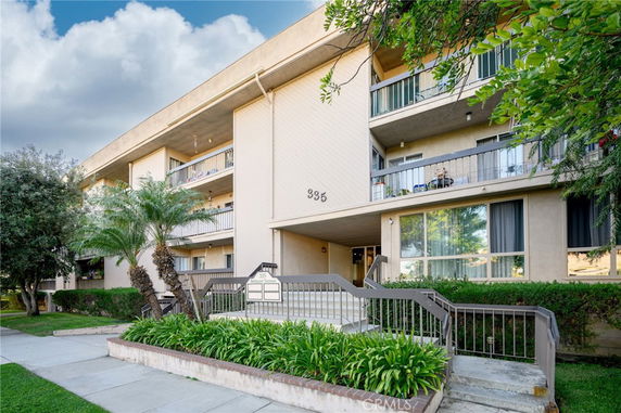 Front view of a multi-story residential building with balconies.