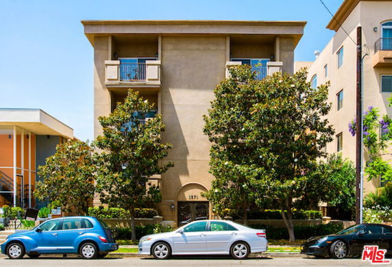 Front view of a multi-story residential building with balconies.