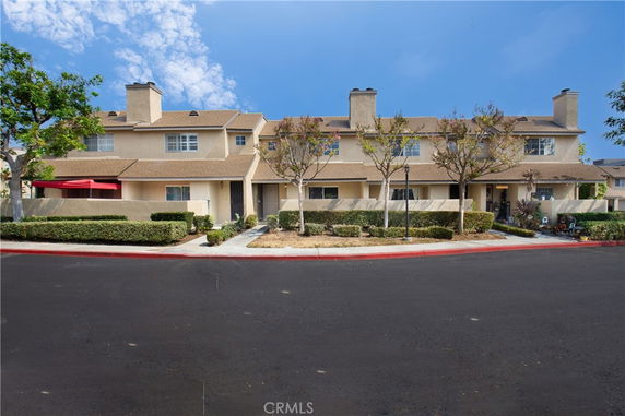Front view of a two-story townhouse building with multiple entrances.