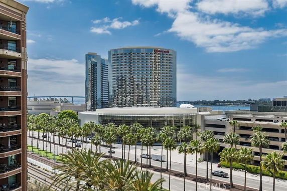 View of multiple mid-rise buildings and a bridge with water in the background.