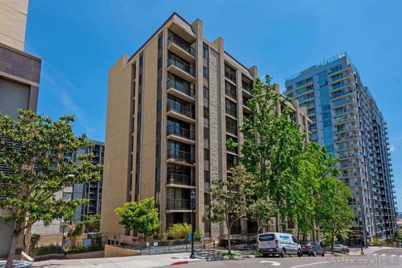 Front view of a multi-story residential building with balconies.