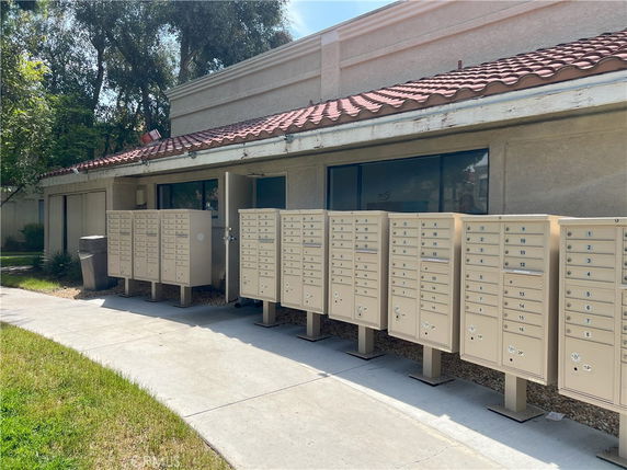 Front view of a building with multiple outdoor mailboxes.