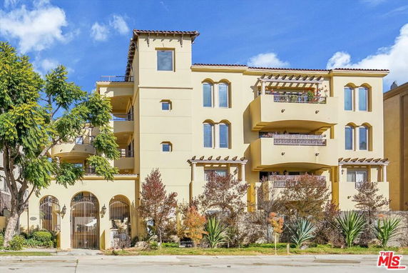 Front view of a multi-story building with balconies.