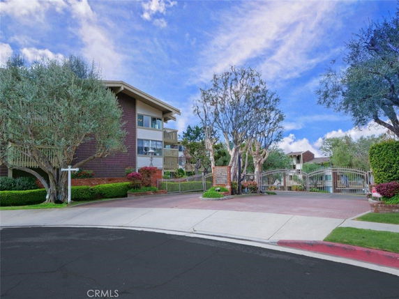 Front view of a multi-story residential building with gated entrance.