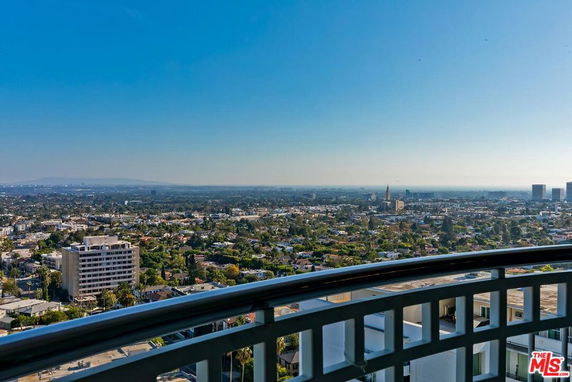 Panoramic view of the city skyline featuring various buildings and a clear sky.