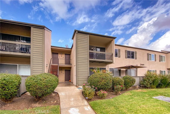 Front view of a two-story residential building with balconies.