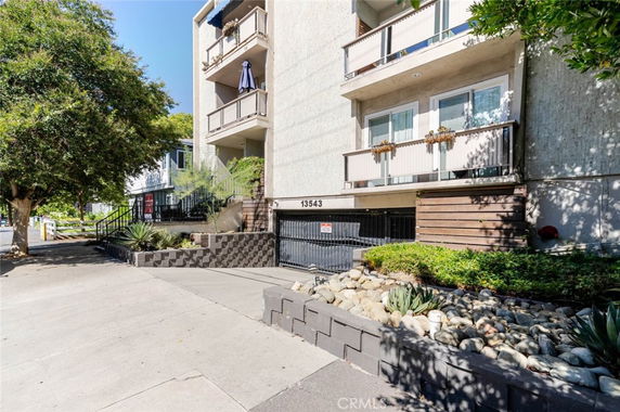 Front view of a residential building with multiple balconies.