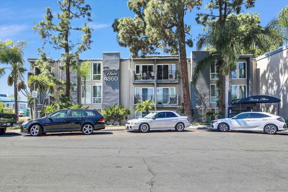 Front view of a multi-story residential building with balconies.