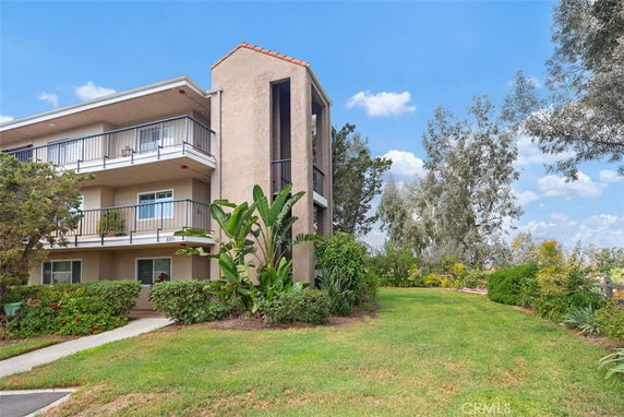 Front view of a multi-story building with balconies.