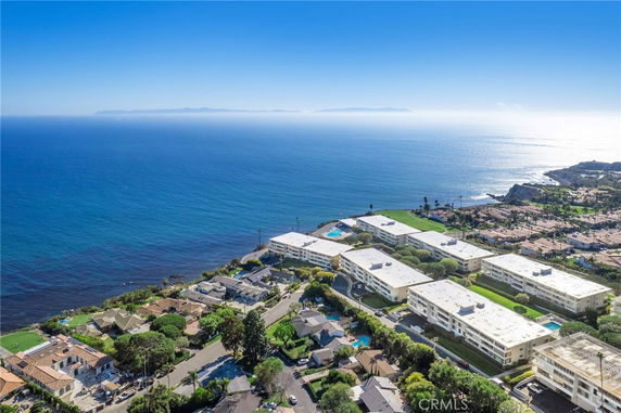 Aerial view of buildings near the coastline with ocean in the background.