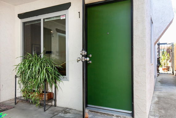 Front view of a house entrance with a green door and window.