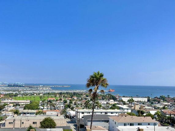 Panoramic view of a coastal area with buildings and the ocean in the background.