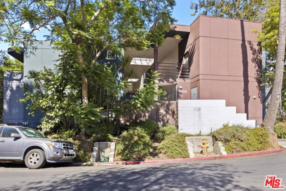 Front view of a modern two-story building with a flat roof and minimalist design.