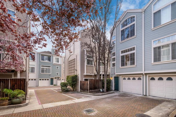 Front view of a multi-story residential building with garages.