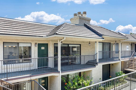 Front view of a two-story residential building with balconies.