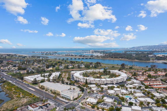Aerial view of residential and commercial buildings near a body of water.